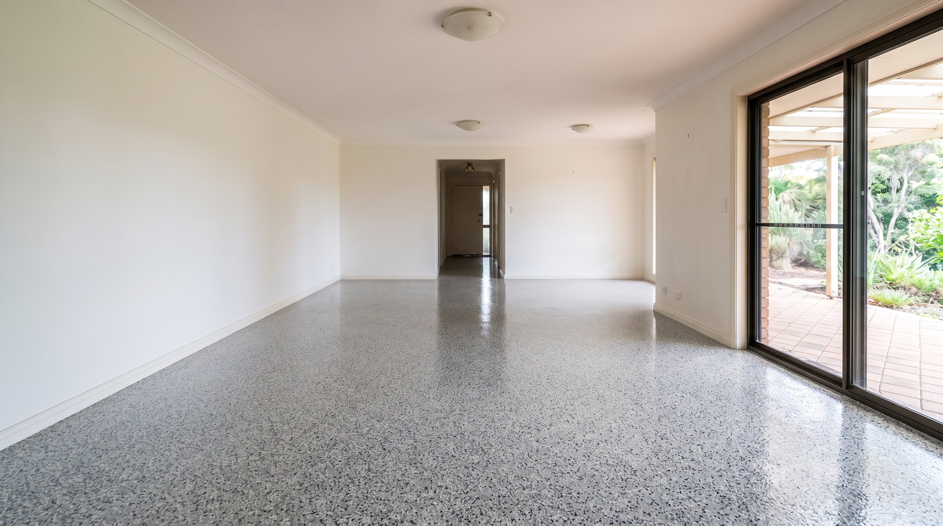 After: full broadcast stone-look flake floor with a high gloss finish