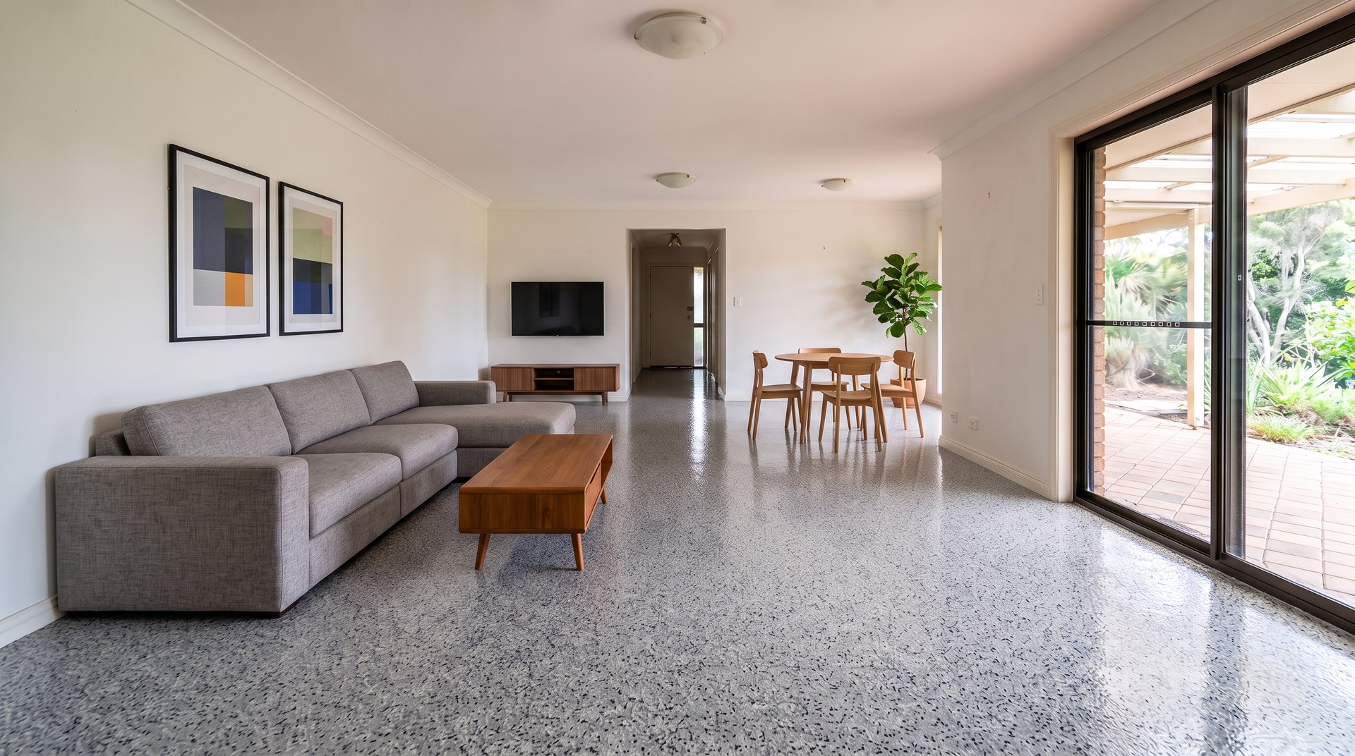 Furnished living area with a full broadcast stone-look flake floor